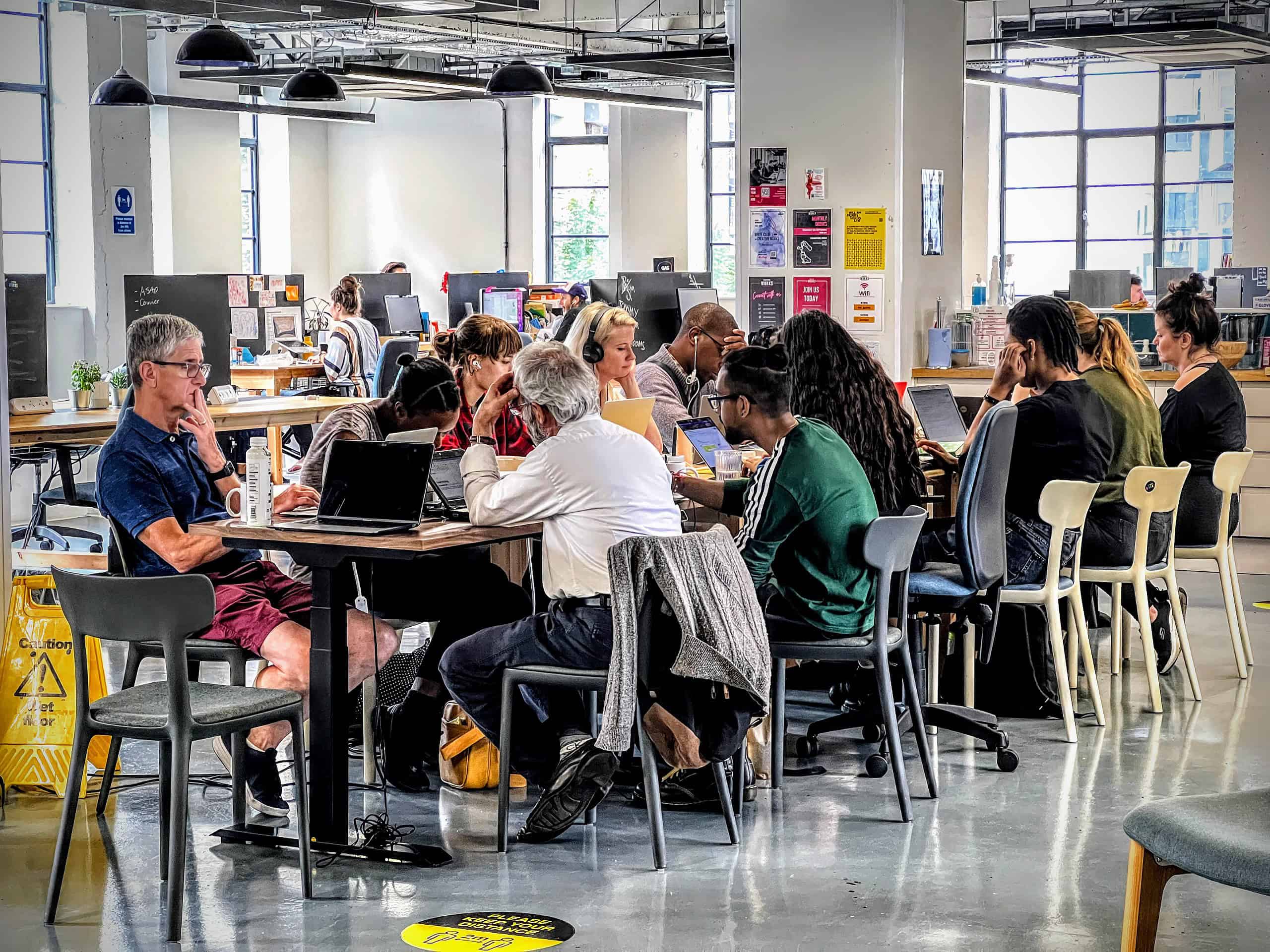 Group of writers around a table at a coworking space